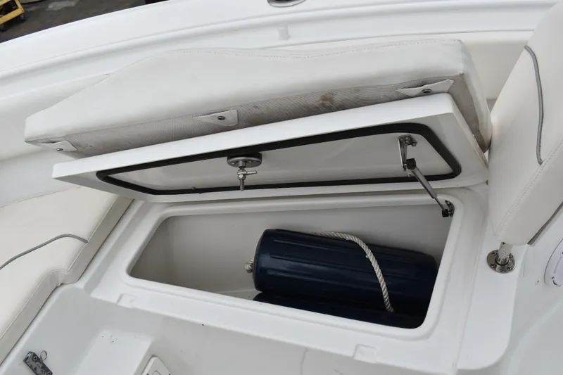 Slide: The Image of Open storage compartment on 2023 Sea Hunt Ultra 255 SE boat, showing interior details. - 38