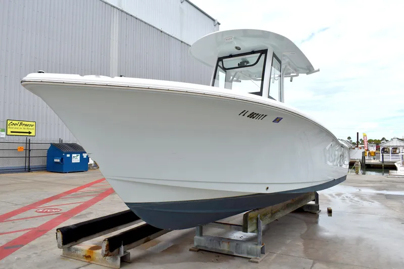 Slide: The Image of 2023 Sea Hunt Ultra 255 SE boat on display at a marina. - 4