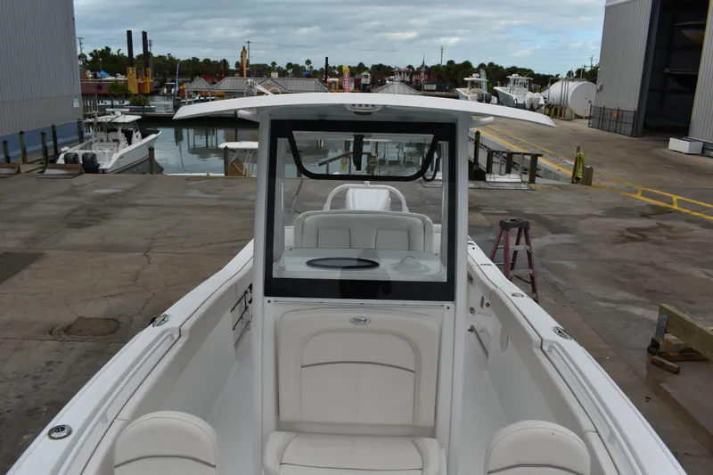 Slide: The Image of 2023 Sea Hunt Ultra 255 SE boat docked at a marina, showcasing sleek design. - 40
