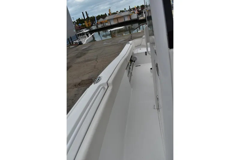 Slide: The Image of 2023 Sea Hunt Ultra 255 SE boat docked at a marina, side view. - 43