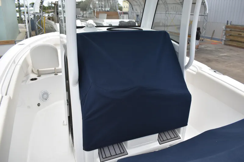 Slide: The Image of 2023 Sea Hunt Ultra 255 SE boat interior with covered console and seating area. - 49