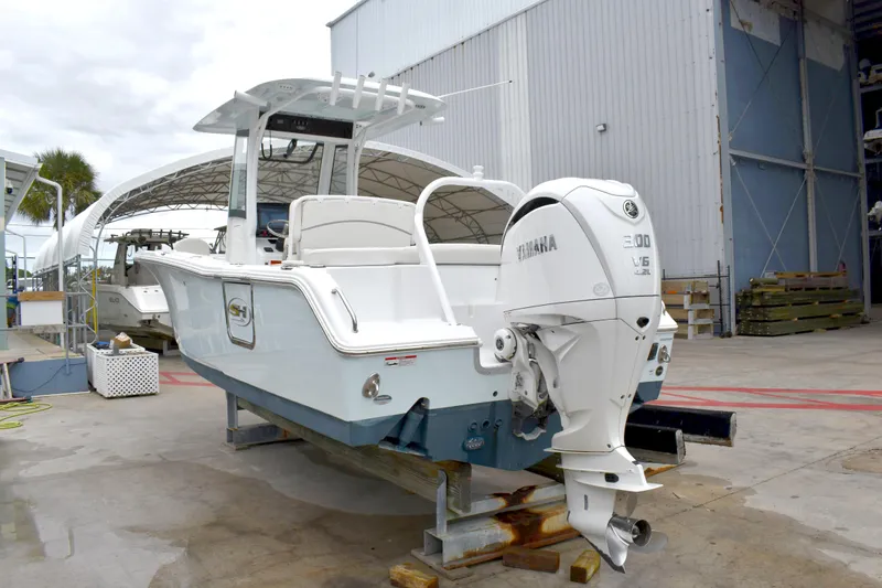 Slide: The Image of 2023 Sea Hunt Ultra 255 SE boat with Yamaha engine in a marina setting. - 51