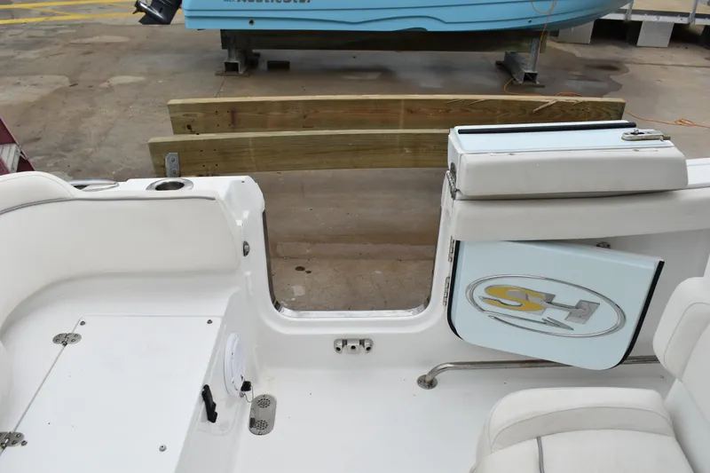 Slide: The Image of 2023 Sea Hunt Ultra 255 SE boat interior with open transom door. - 7