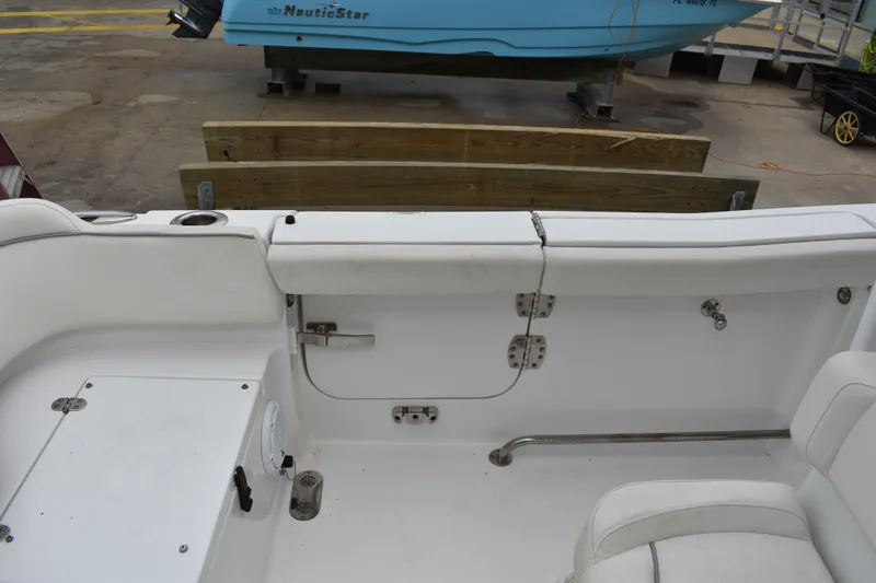 Slide: The Image of 2023 Sea Hunt Ultra 255 SE boat interior with white seating and storage compartments. - 8