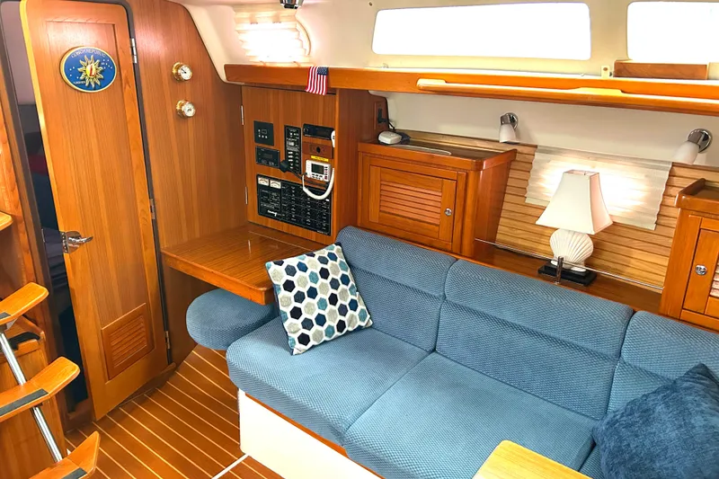 Slide: The Image of Interior of 2009 Catalina 375 sailboat with cozy seating and wooden cabinetry. - 10