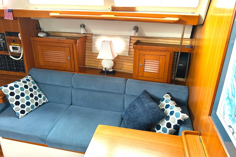 Slide: The Image of Interior of 2009 Catalina 375 sailboat with blue seating and decorative pillows. - 11