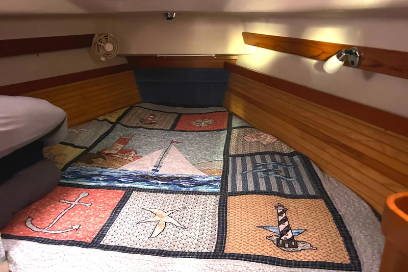 Slide: The Image of Cozy cabin interior of 2009 Catalina 375 sailboat with nautical-themed quilt. - 12