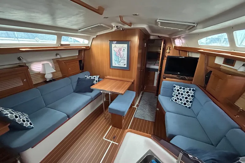 Slide: The Image of Luxurious interior of 2009 Catalina 375 sailboat with blue seating and wooden accents. - 15
