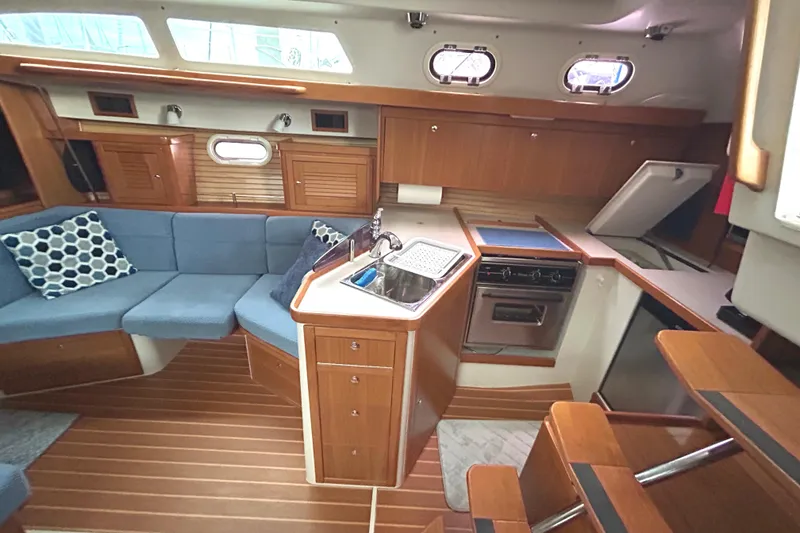 Slide: The Image of Interior of 2009 Catalina 375 sailboat with cozy seating and modern kitchen amenities. - 18