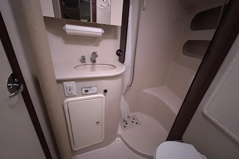 Slide: The Image of 2009 Catalina 375 yacht bathroom with sink, mirror, and shower area. - 21