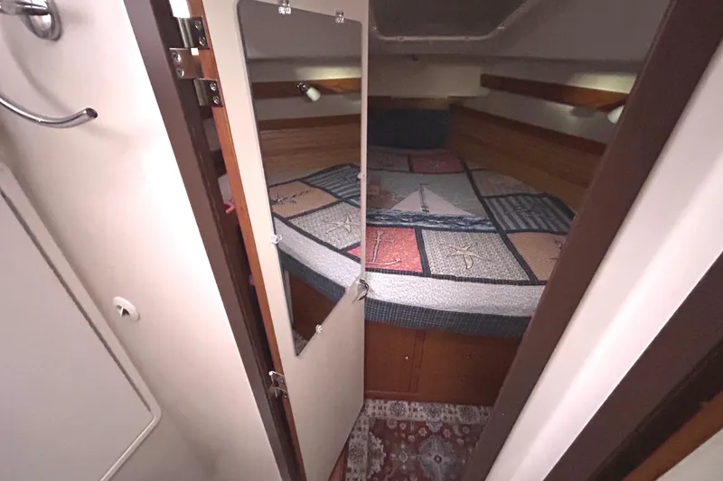 Slide: The Image of Cozy cabin interior of 2009 Catalina 375 sailboat with nautical-themed bedding. - 23