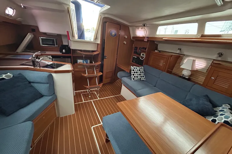 Slide: The Image of Interior of a 2009 Catalina 375 sailboat with cozy seating and wooden finishes. - 25