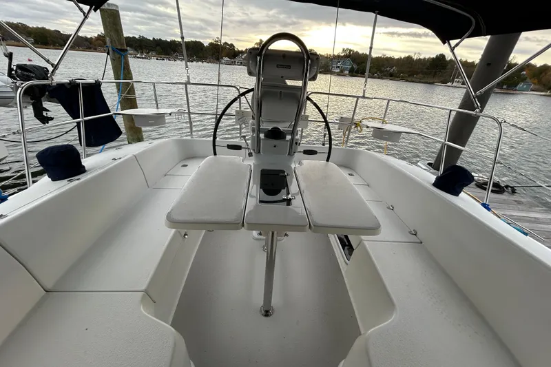 Slide: The Image of 2009 Catalina 375 sailboat cockpit with dual helm, docked by a serene waterfront. - 32
