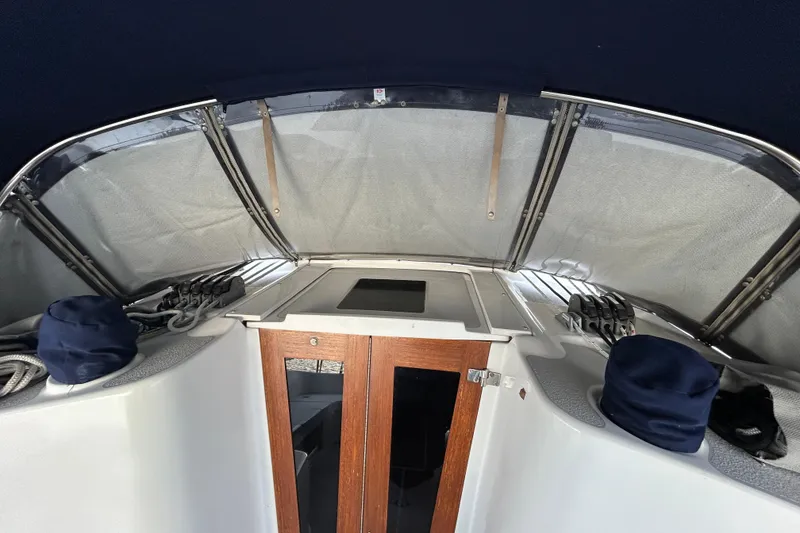 Slide: The Image of 2009 Catalina 375 sailboat cockpit with covered ropes and wooden hatch. - 38