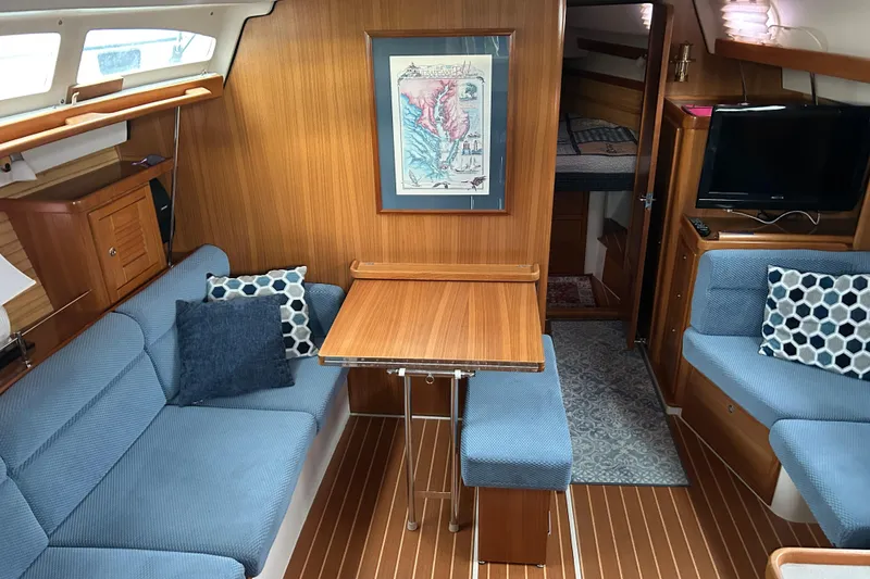 Slide: The Image of Interior of a 2009 Catalina 375 sailboat with blue seating and wooden accents. - 7