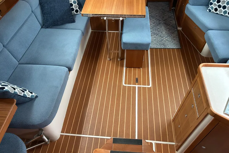 Slide: The Image of Interior of 2009 Catalina 375 sailboat with blue seating and wooden flooring. - 8