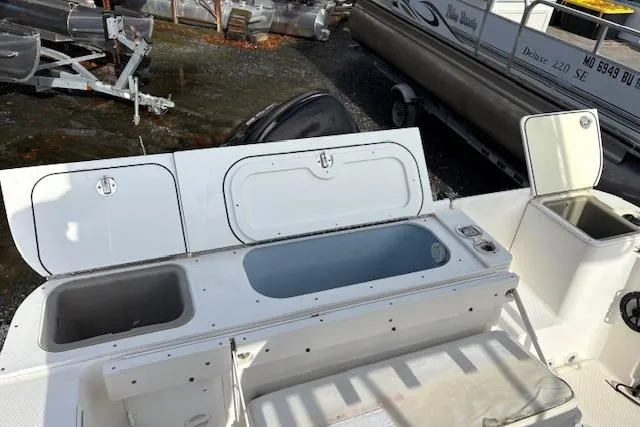 Slide: The Image of 2006 Trophy PRO 23 Center Console boat with open storage compartments and seating area. - 10