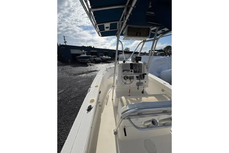 Slide: The Image of 2006 Trophy PRO 23 Center Console boat with blue canopy, docked outdoors. - 5