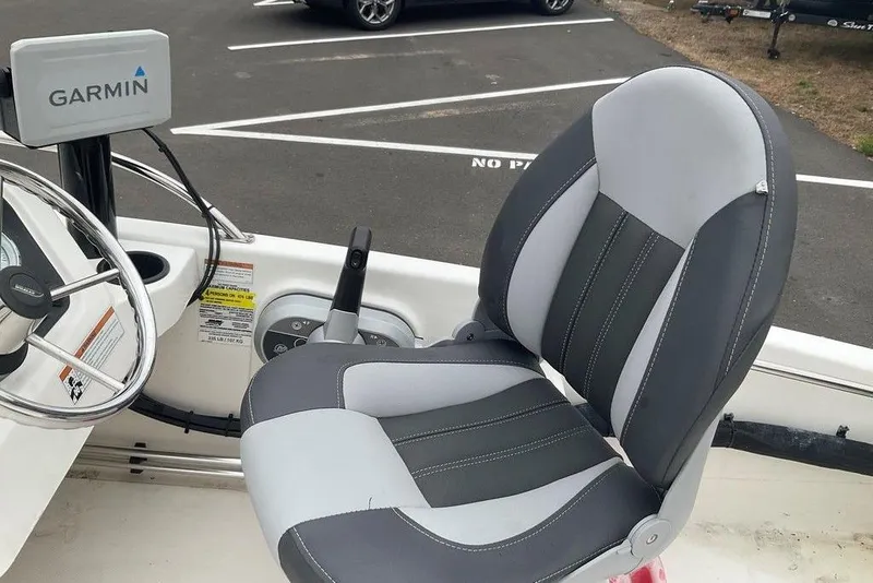 Slide: The Image of 2020 Boston Whaler 130 Super Sport boat interior with Garmin navigation system and cushioned seat. - 13