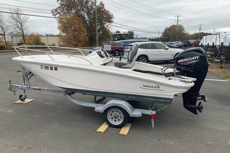 Slide: The Image of 2020 Boston Whaler 130 Super Sport boat on trailer with Mercury outboard motor. - 4