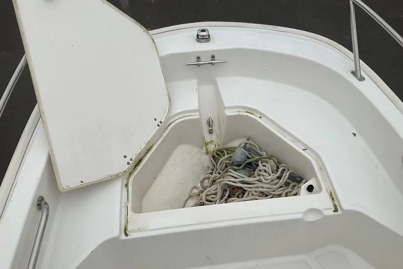 Slide: The Image of Open storage compartment on 2020 Boston Whaler 130 Super Sport boat with ropes inside. - 6