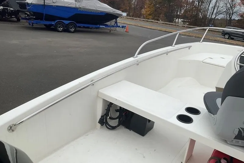 Slide: The Image of 2020 Boston Whaler 130 Super Sport boat interior with seating and cup holders. - 9
