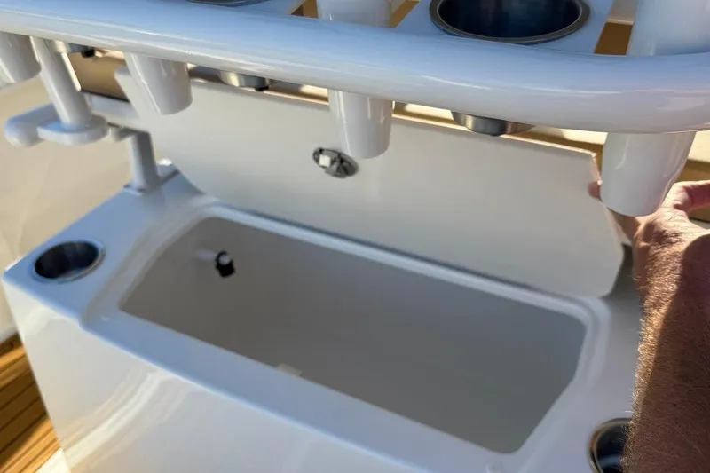 Slide: The Image of 2026 Bayliner Trophy T22CC boat's livewell and rod holders in close-up view. - 10