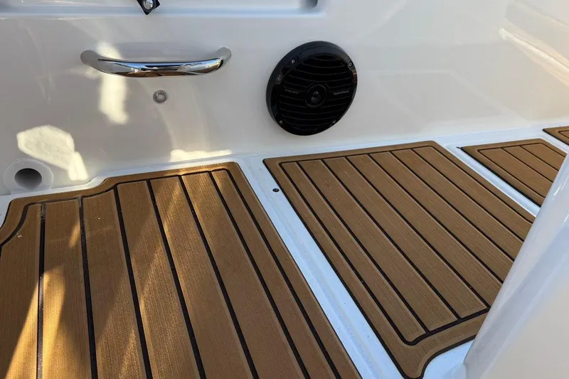 Slide: The Image of 2026 Bayliner Trophy T22CC boat deck with wood finish and speaker. - 12