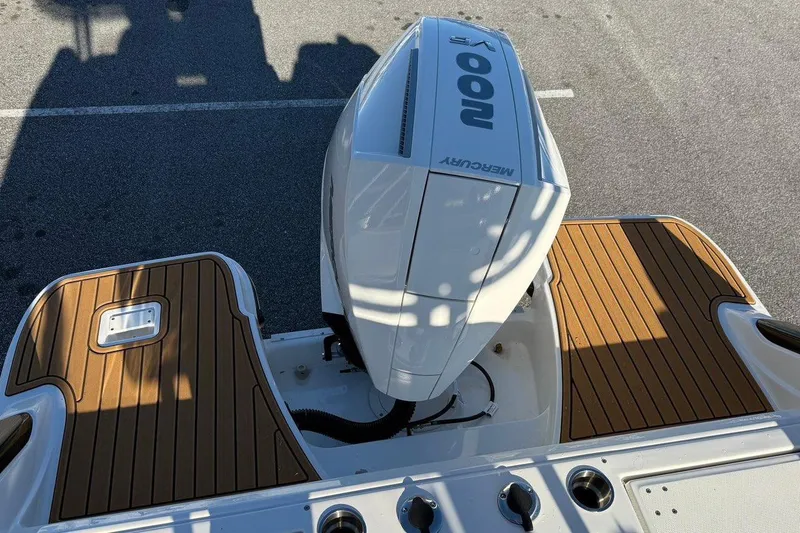 Slide: The Image of 2026 Bayliner Trophy T22CC boat with Mercury 200 engine, featuring teak-style decking. - 13