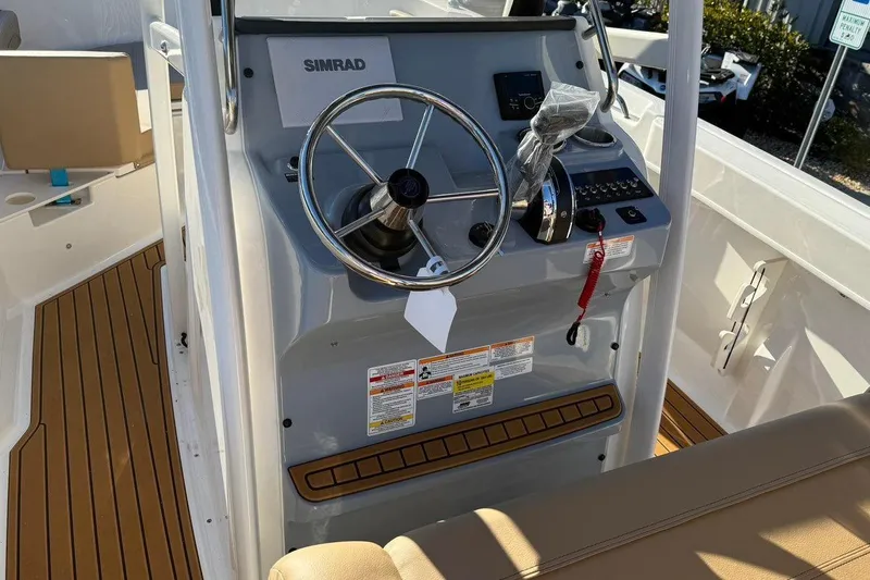 Slide: The Image of 2026 Bayliner Trophy T22CC boat console with steering wheel and controls. - 14