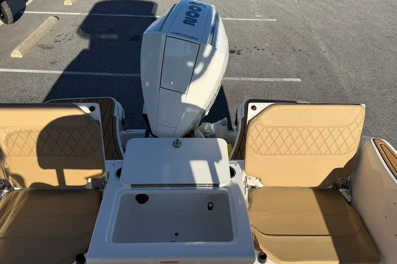 Slide: The Image of 2026 Bayliner Trophy T22CC boat interior with tan seats and outboard motor. - 20