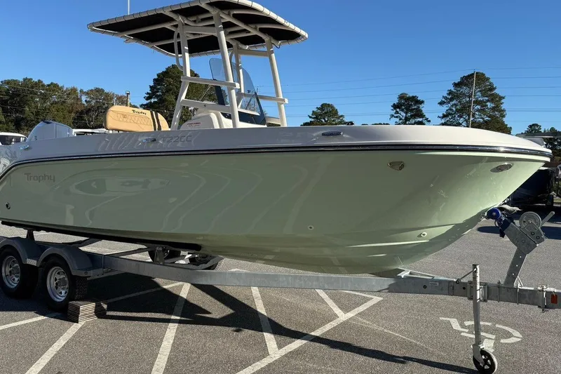 Slide: The Image of 2026 Bayliner Trophy T22CC boat on trailer in parking lot, sunny day. - 3