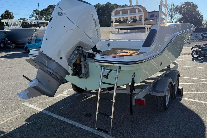 Slide: The Image of 2026 Bayliner Trophy T22CC boat on trailer, featuring a powerful Mercury outboard engine. - 5