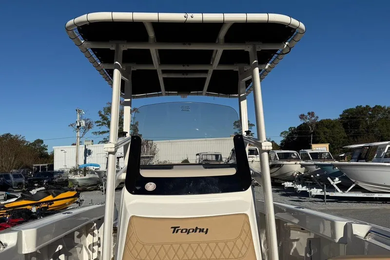 Slide: The Image of 2026 Bayliner Trophy T22CC boat with T-top, displayed outdoors under clear blue sky. - 7