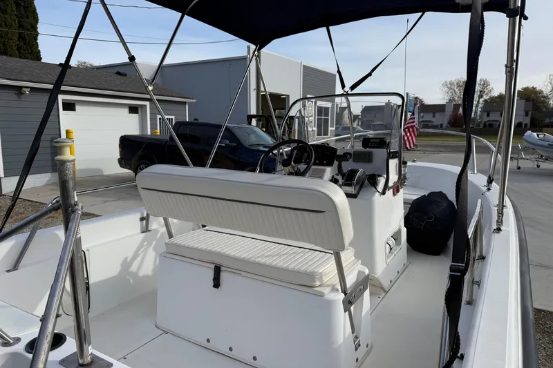 Slide: The Image of 2004 Boston Whaler 160 Dauntless boat interior with steering console and seating. - 5