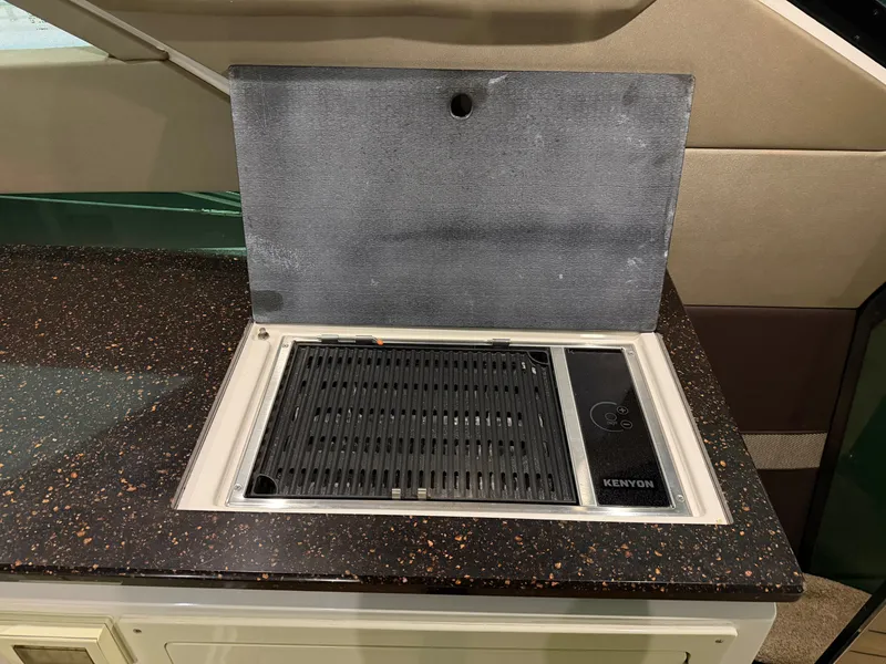 Slide: The Image of Built-in Kenyon grill on 2014 Regal 52 Sport Coupe yacht's countertop. - 11