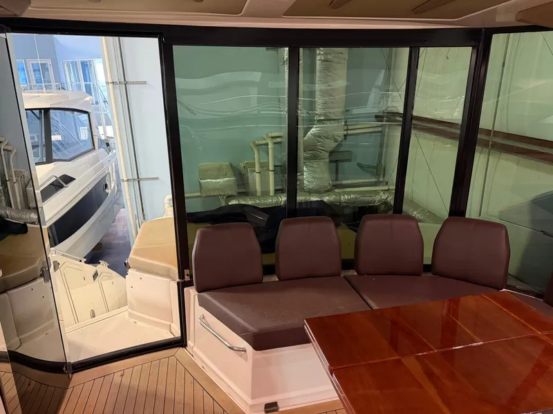 Slide: The Image of Interior of 2014 Regal 52 Sport Coupe yacht with seating and table. - 12