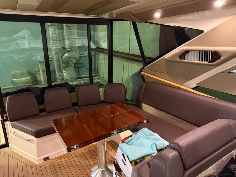 Slide: The Image of Interior of 2014 Regal 52 Sport Coupe with seating and wooden table. - 13