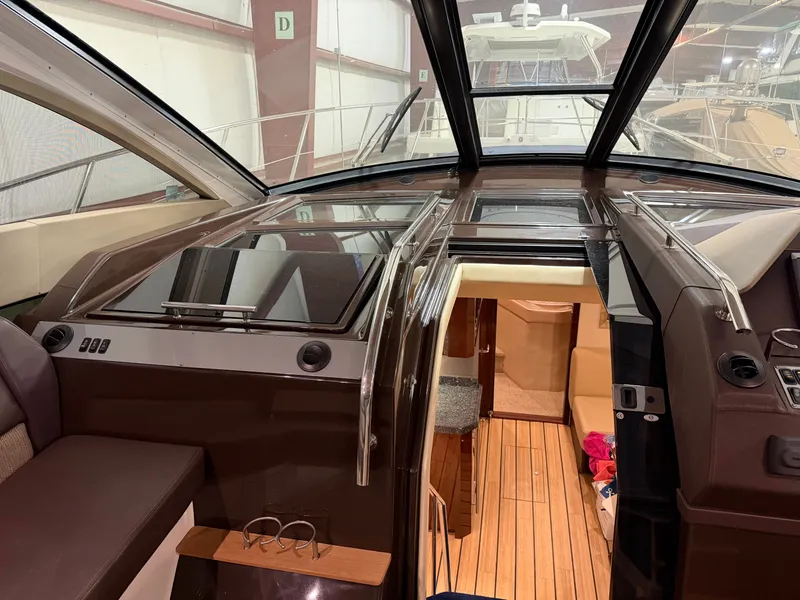 Slide: The Image of Interior view of a 2014 Regal 52 Sport Coupe yacht with sleek design and wood flooring. - 15