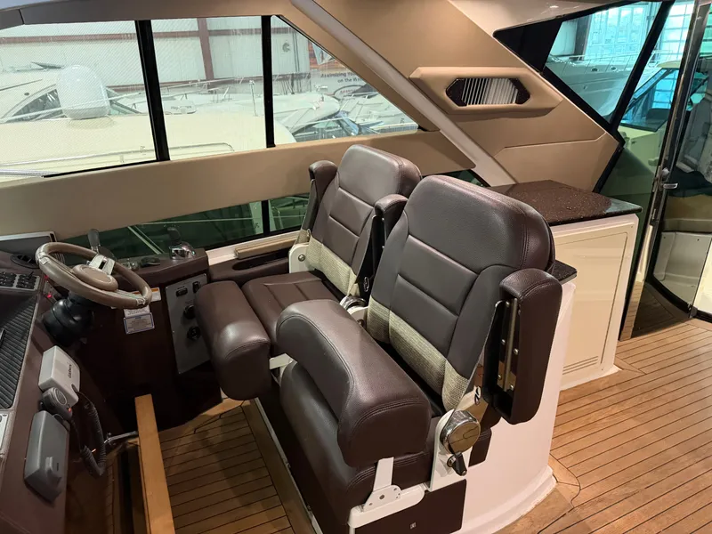 Slide: The Image of Interior of 2014 Regal 52 Sport Coupe with leather seats and wooden flooring. - 17