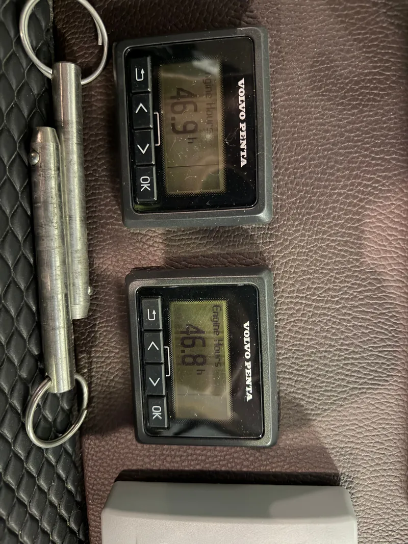 Slide: The Image of Volvo Penta engine hour meters on 2014 Regal 52 Sport Coupe dashboard. - 19