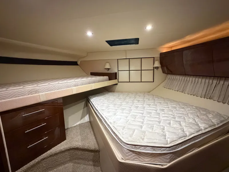 Slide: The Image of Interior cabin of 2014 Regal 52 Sport Coupe with twin beds and wooden cabinetry. - 24