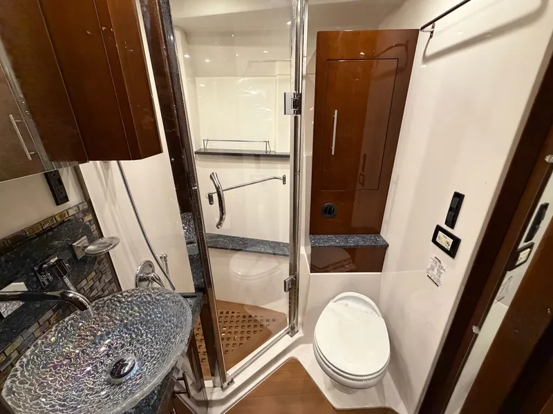Slide: The Image of Luxurious bathroom in 2014 Regal 52 Sport Coupe yacht with glass sink and shower. - 25