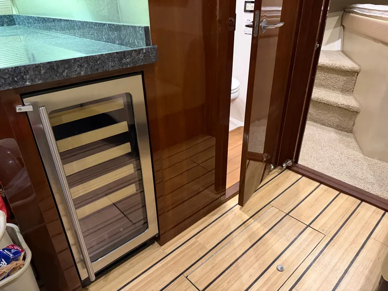 Slide: The Image of Interior of 2014 Regal 52 Sport Coupe with wine cooler and wooden flooring. - 26