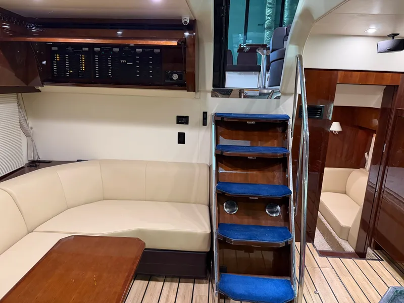 Slide: The Image of Luxurious interior of 2014 Regal 52 Sport Coupe yacht with seating and stairs. - 27