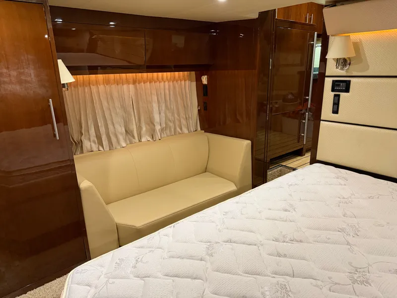 Slide: The Image of Luxurious interior of 2014 Regal 52 Sport Coupe with beige sofa and elegant wood finishes. - 32