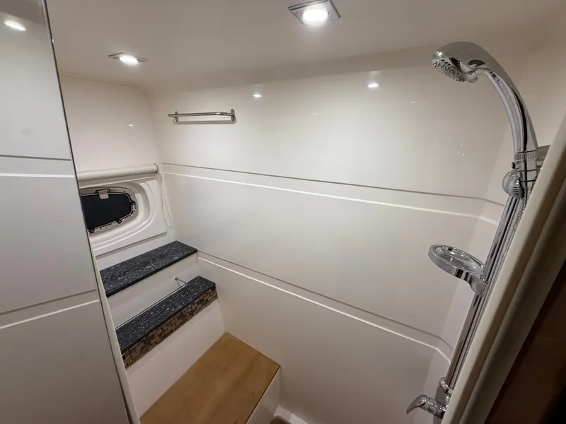 Slide: The Image of Luxurious shower area in 2014 Regal 52 Sport Coupe yacht, featuring modern fixtures and lighting. - 34