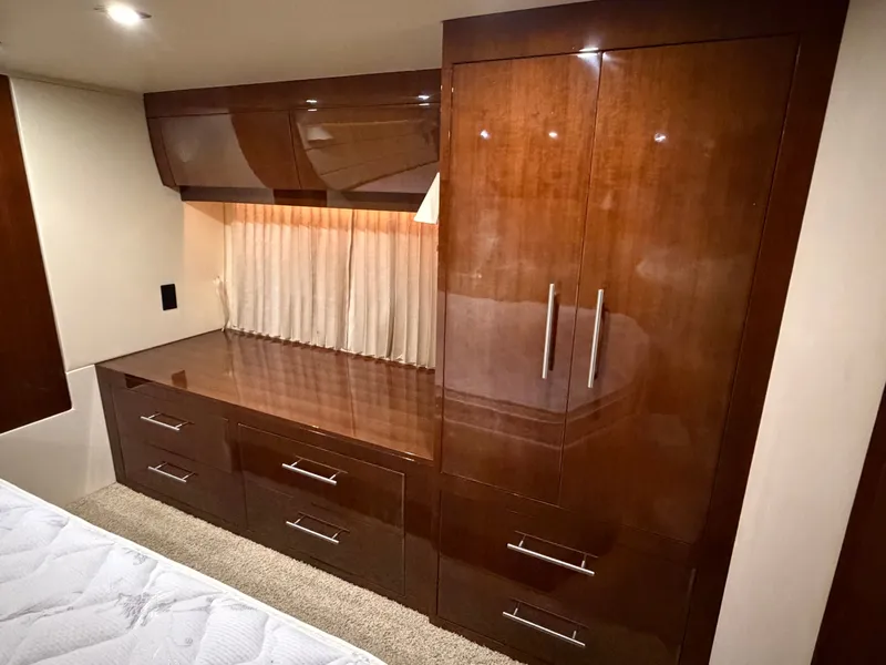 Slide: The Image of Luxurious wood cabinetry in 2014 Regal 52 Sport Coupe interior, featuring ample storage and elegant design. - 35