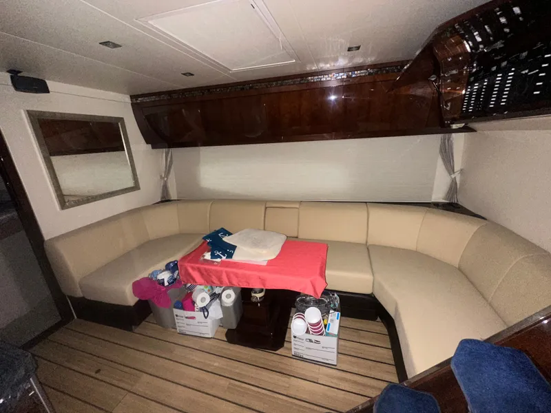 Slide: The Image of Luxurious interior of 2014 Regal 52 Sport Coupe yacht with elegant seating and wooden flooring. - 7