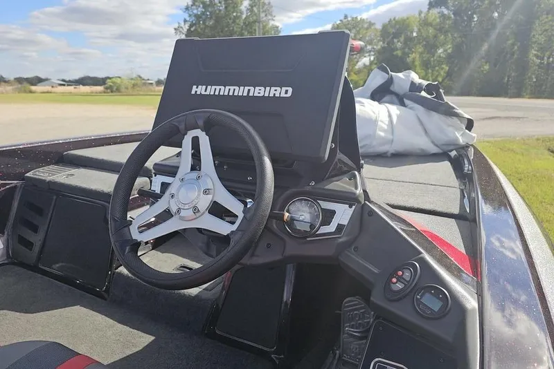 Slide: The Image of 2019 Skeeter FX21 boat dashboard with Humminbird display and steering wheel. - 10